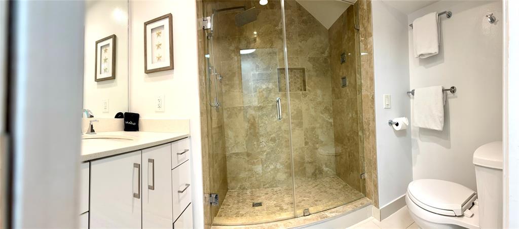 1705 North Riverside Drive, Unit 2 Pompano Beach, FL 33062 - Photo 25 of 60 a bathroom with a shower a toilet and a sink