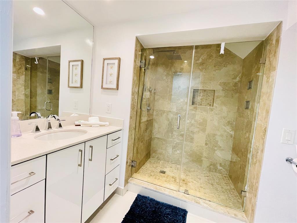 1705 North Riverside Drive, Unit 2 Pompano Beach, FL 33062 - Photo 26 of 60 a bathroom with a shower sink and mirror