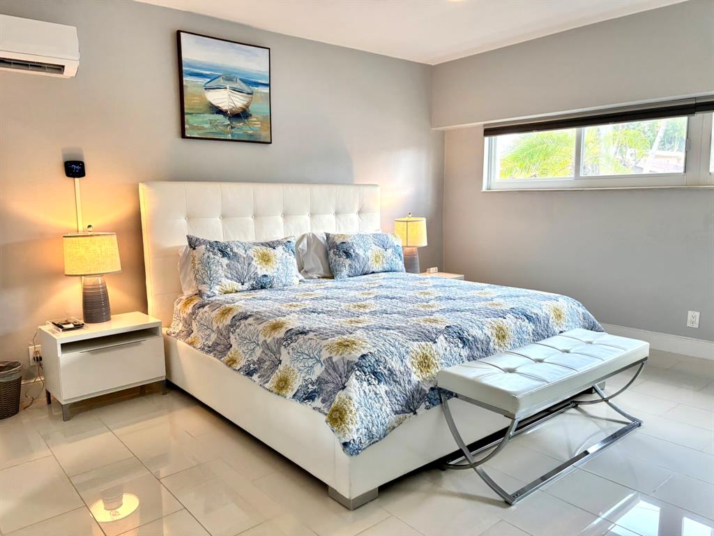 1705 North Riverside Drive, Unit 2 Pompano Beach, FL 33062 - Photo 34 of 60 a bed sitting in a bedroom next to a window