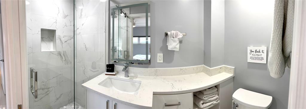 1705 North Riverside Drive, Unit 2 Pompano Beach, FL 33062 - Photo 38 of 60 a bathroom with a sink and mirror with toilet