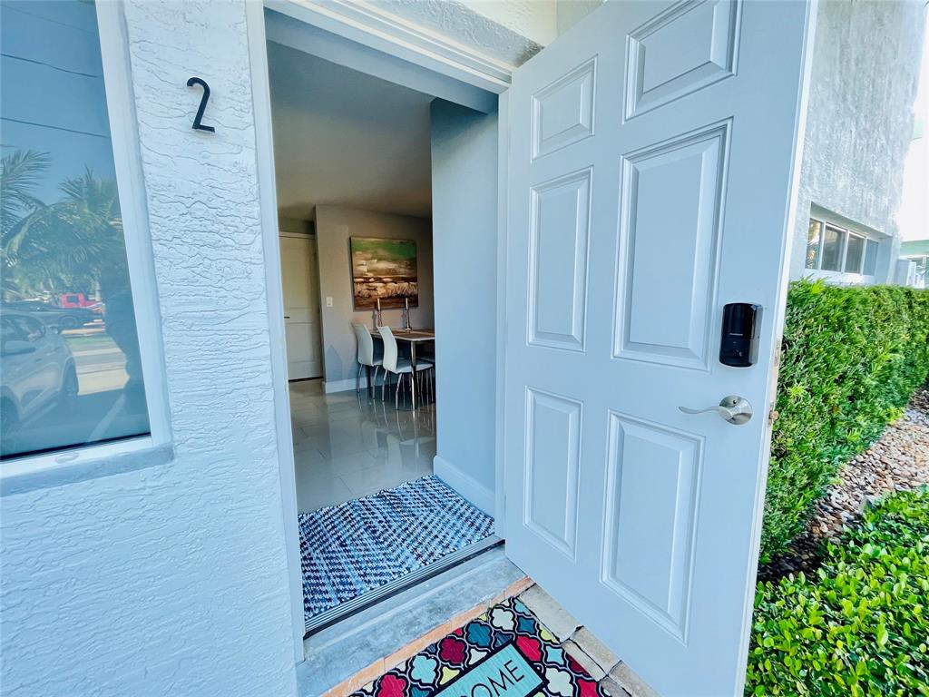 1705 North Riverside Drive, Unit 2 Pompano Beach, FL 33062 - Photo 4 of 60 a view of entryway and hall with dining room