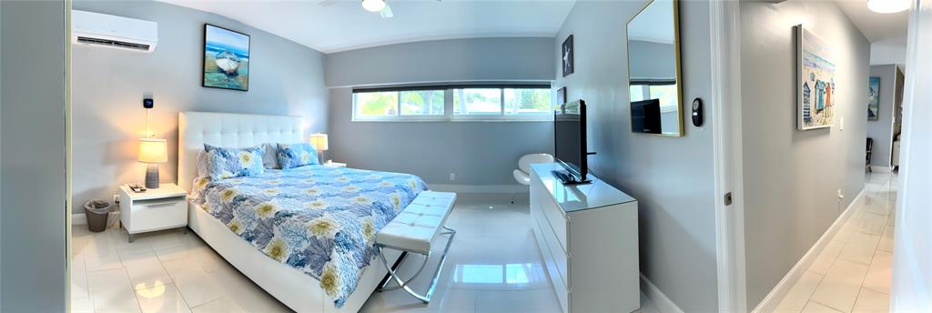 1705 North Riverside Drive, Unit 2 Pompano Beach, FL 33062 - Photo 41 of 60 a bedroom with a bed and a mirror on the dresser