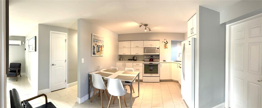 1705 North Riverside Drive, Unit 2 Pompano Beach, FL 33062 - Photo 7 of 60 a kitchen with a refrigerator and countertop