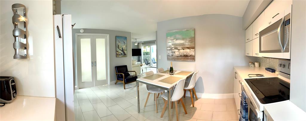 1705 North Riverside Drive, Unit 2 Pompano Beach, FL 33062 - Photo 8 of 60 a living room with furniture and a flat screen tv