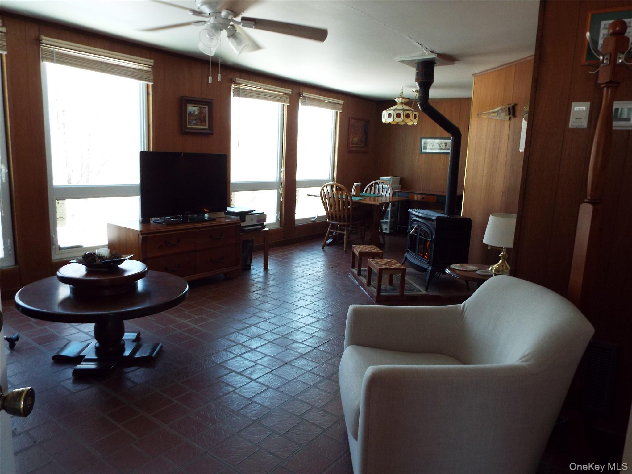 2492 State Rt 17B Bethel, NY 12726 - Photo 11 of 26 a living room with furniture and a flat screen tv