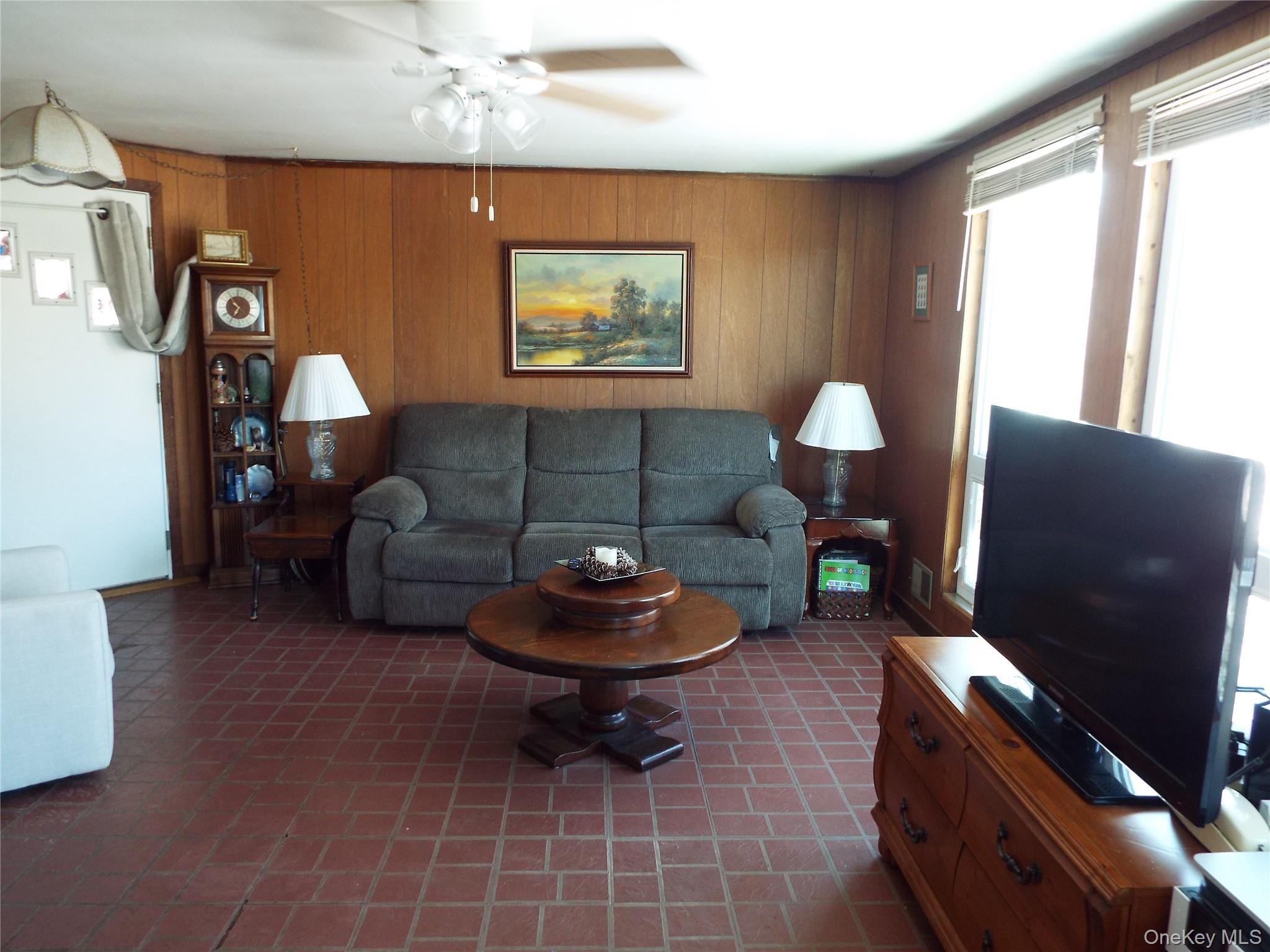2492 State Rt 17B Bethel, NY 12726 - Photo 12 of 26 a living room with furniture a window and a flat screen tv