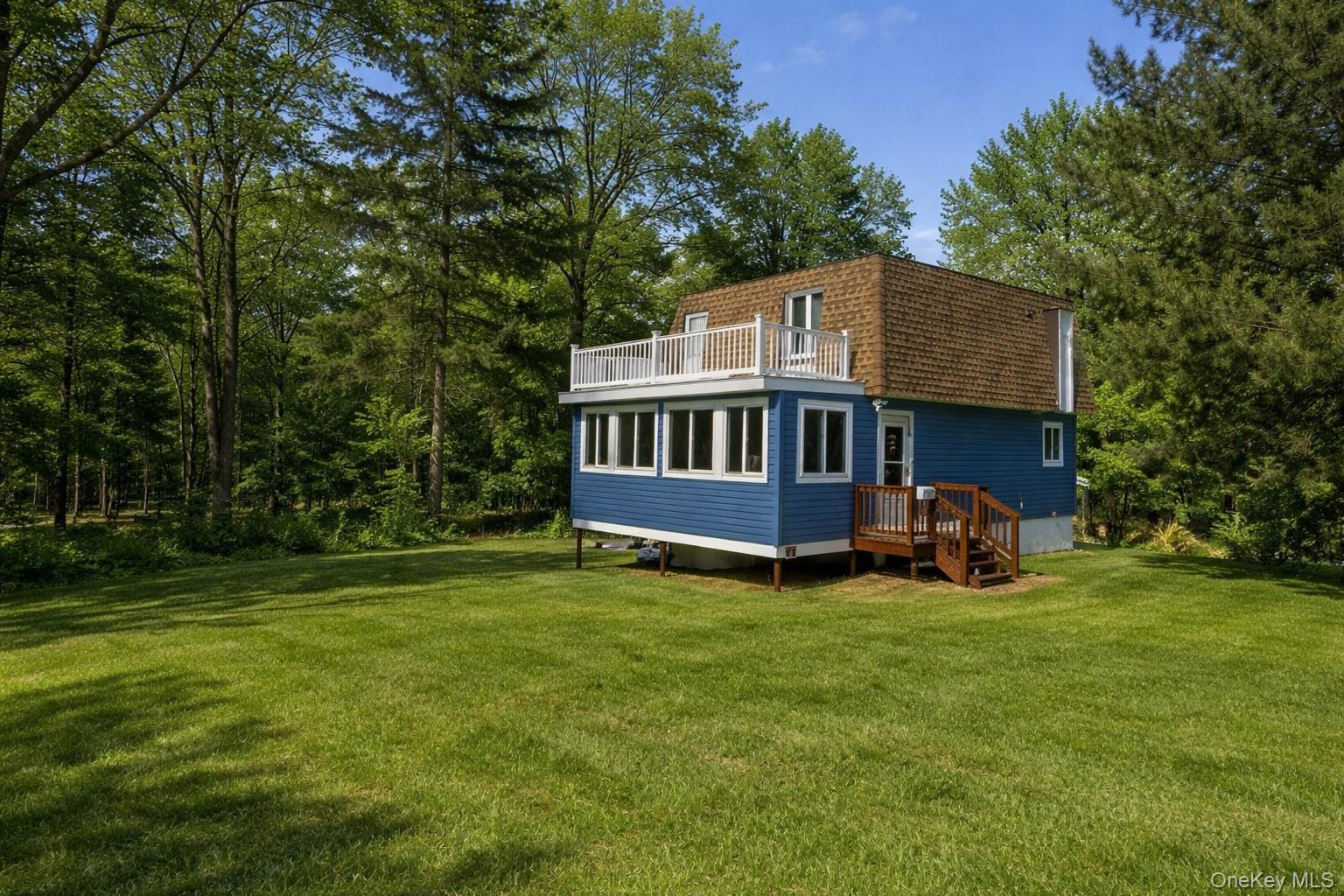 2492 State Rt 17B Bethel, NY 12726 - Photo 3 of 26 a view of backyard with a garden and deck
