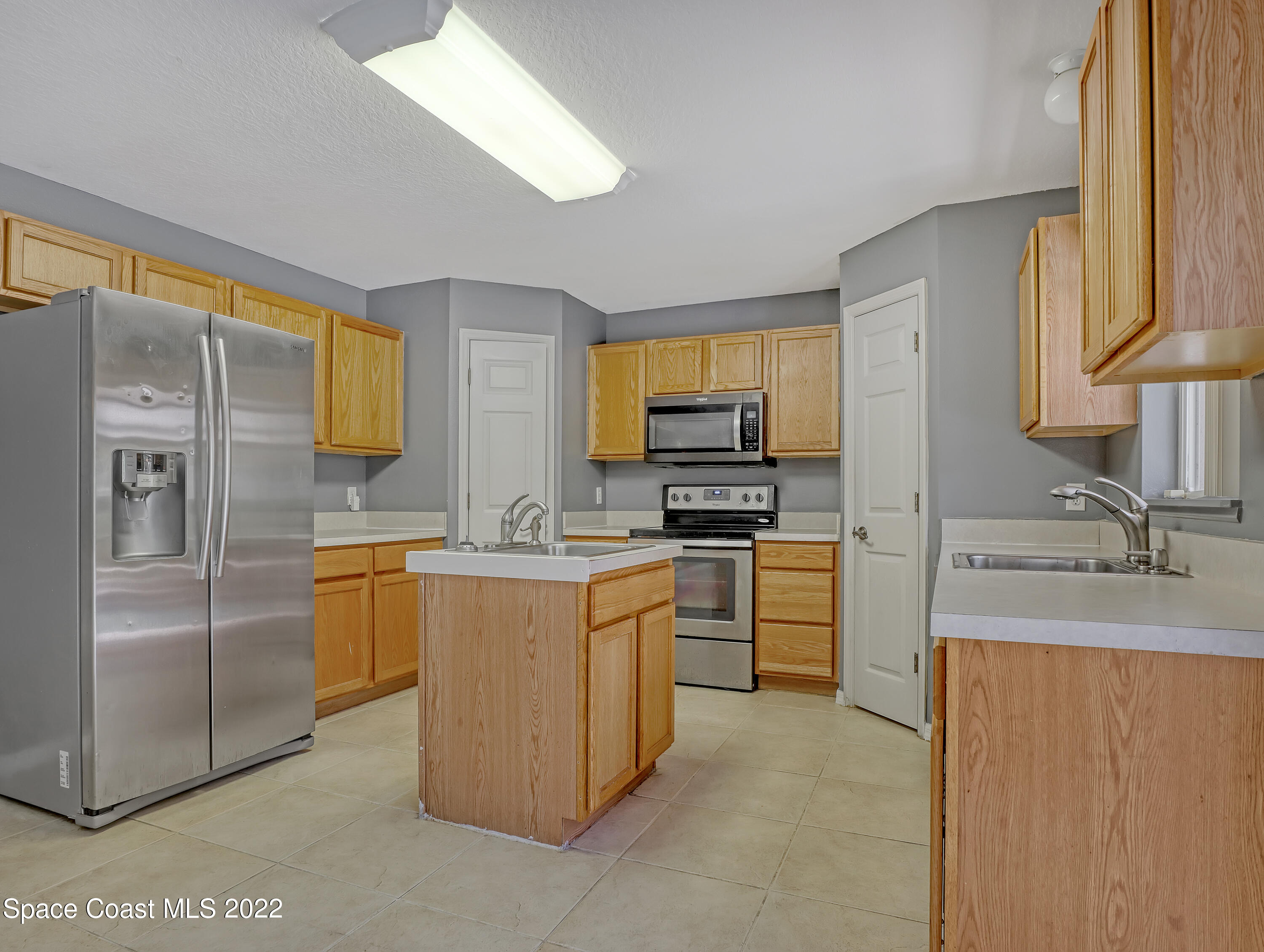 4764 Doreen Road Cocoa, FL 32927 - Photo 15 of 54 a kitchen with stainless steel appliances granite countertop a refrigerator sink and stove
