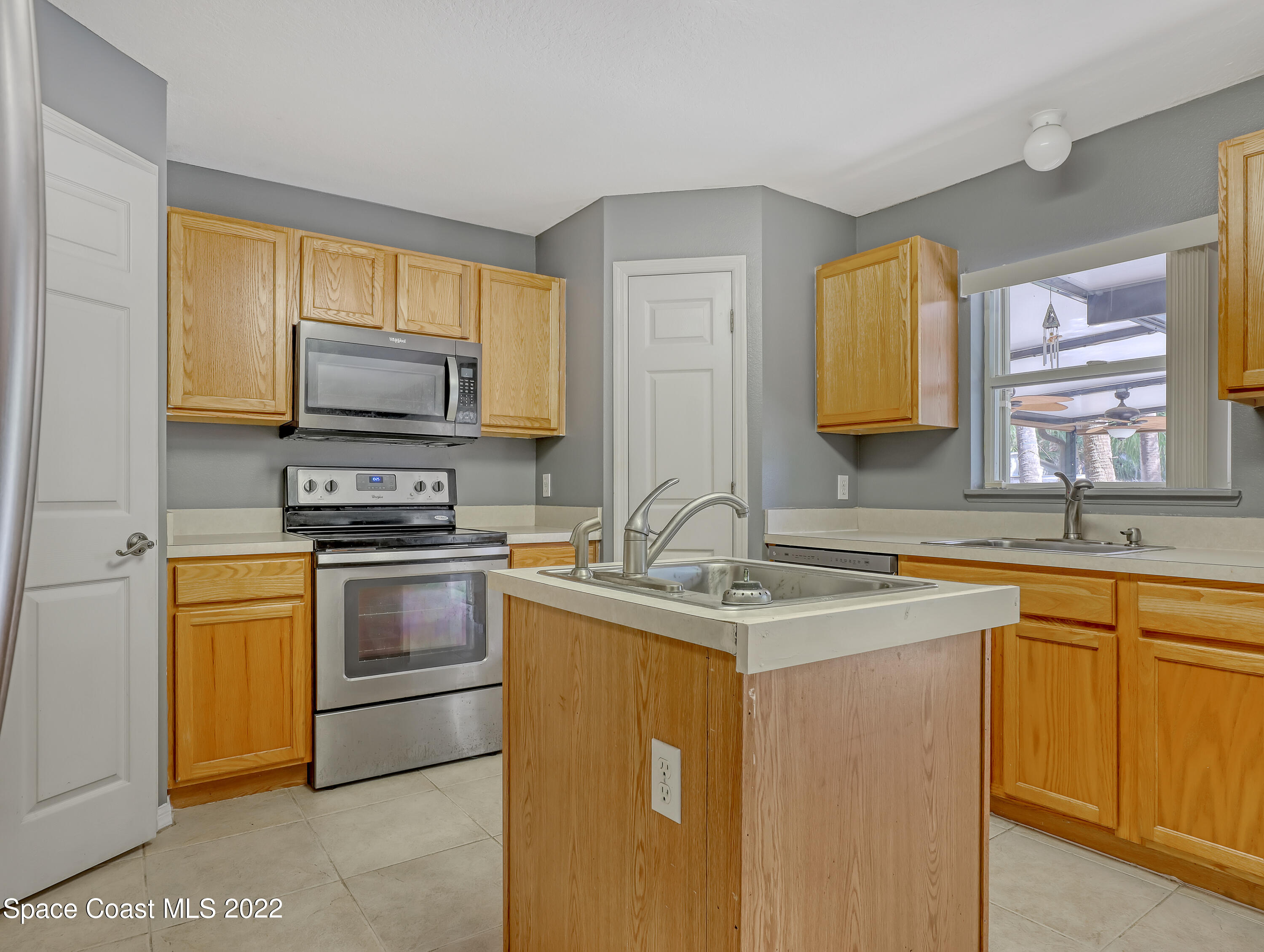 4764 Doreen Road Cocoa, FL 32927 - Photo 16 of 54 a kitchen with stainless steel appliances granite countertop a sink stove and microwave