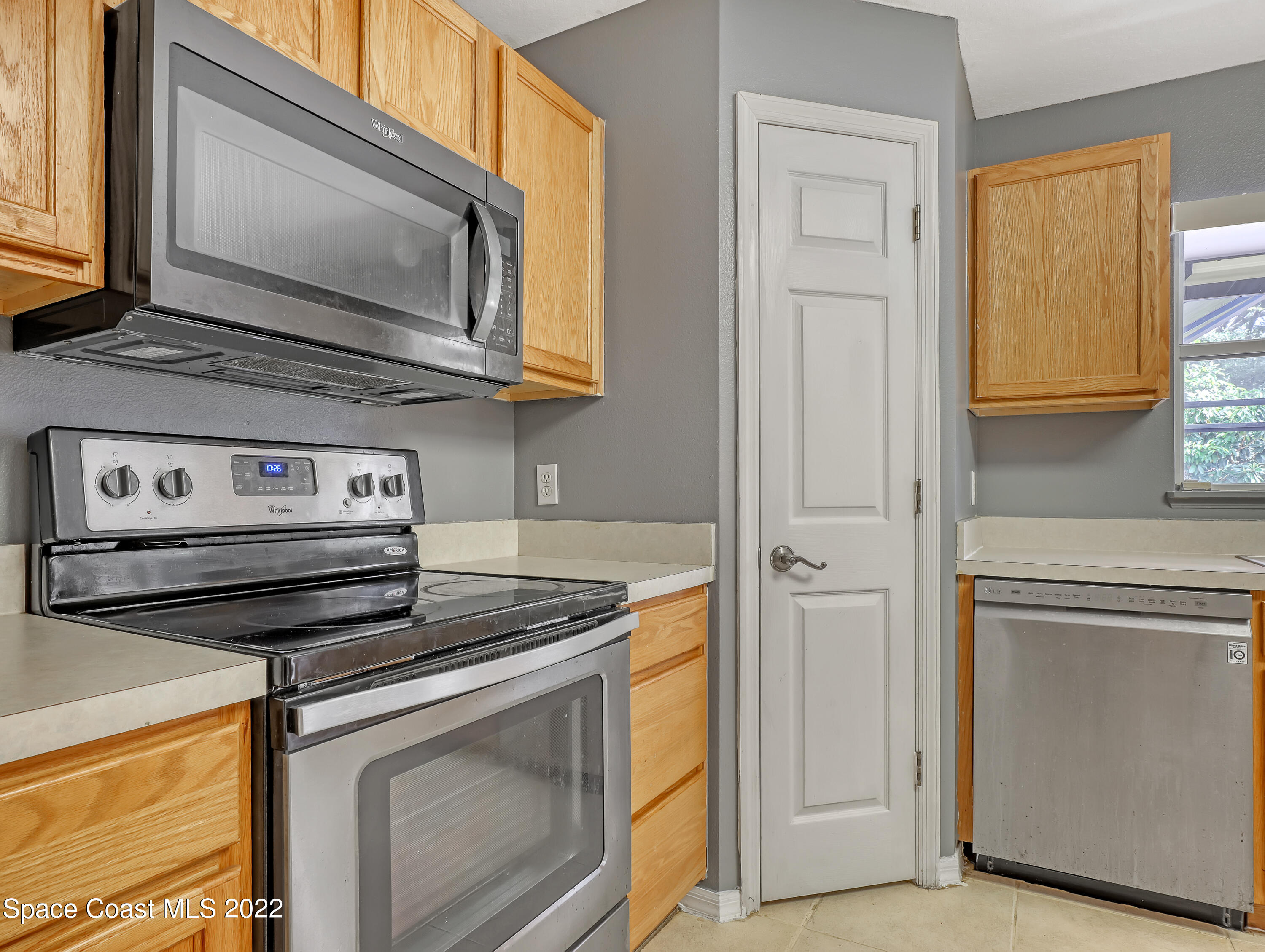 4764 Doreen Road Cocoa, FL 32927 - Photo 17 of 54 a kitchen with stainless steel appliances granite countertop white cabinets and a stove top oven