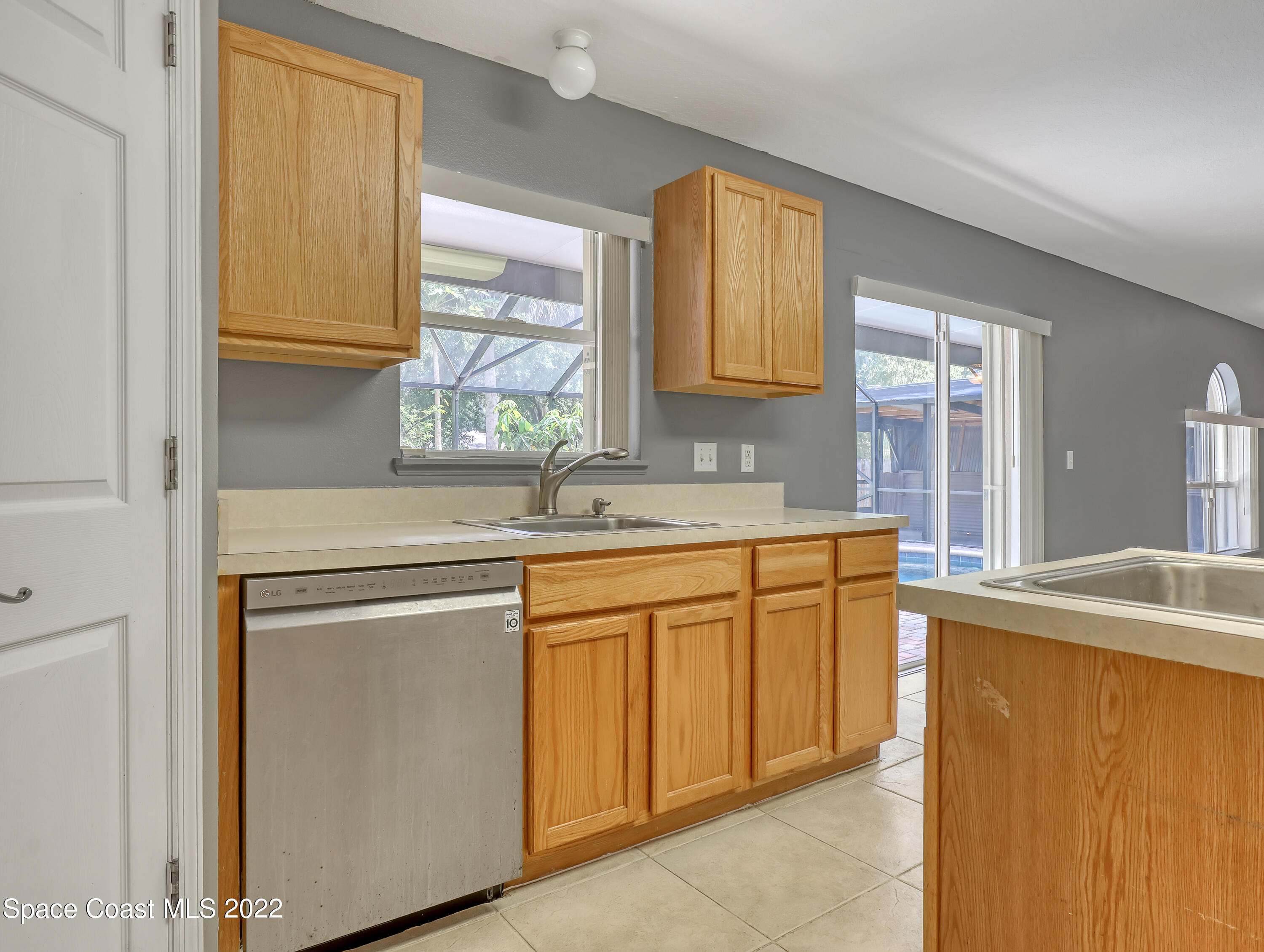 4764 Doreen Road Cocoa, FL 32927 - Photo 18 of 54 a kitchen with stainless steel appliances granite countertop a sink stove and cabinets