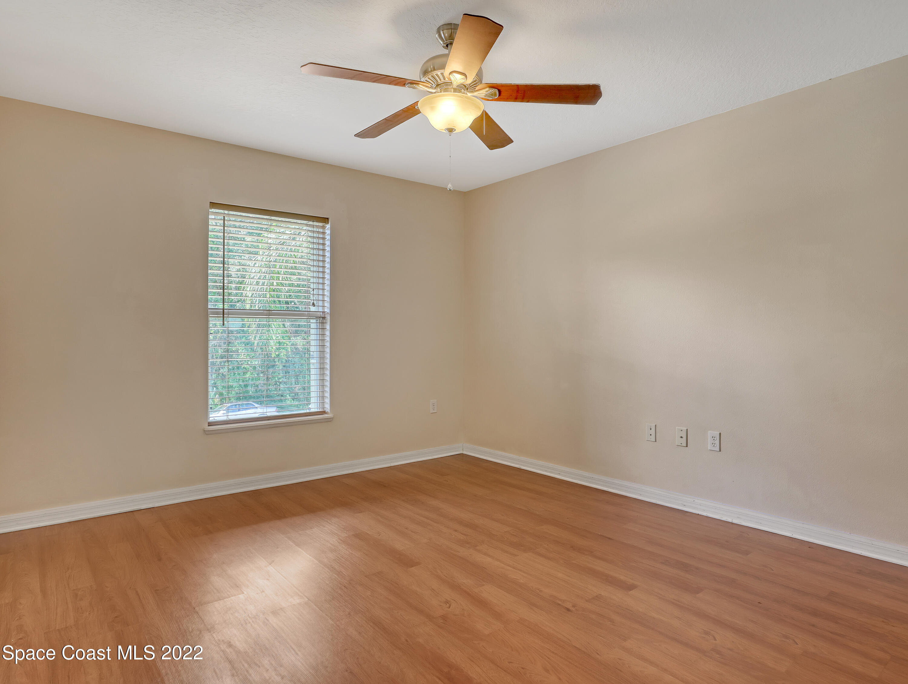 4764 Doreen Road Cocoa, FL 32927 - Photo 21 of 54 an empty room with a window and a chandelier fan