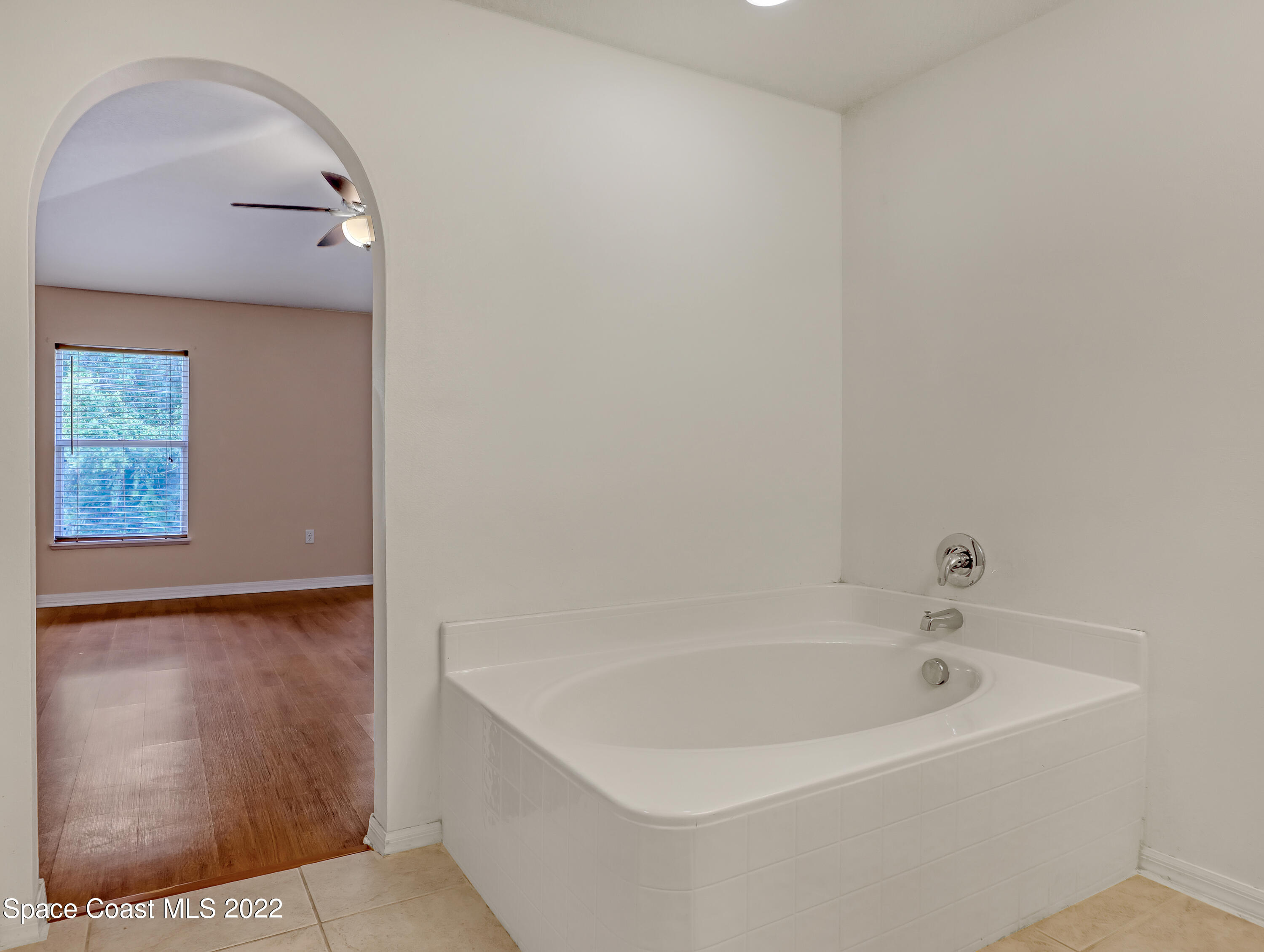 4764 Doreen Road Cocoa, FL 32927 - Photo 26 of 54 a white bath tub sitting in a bathroom