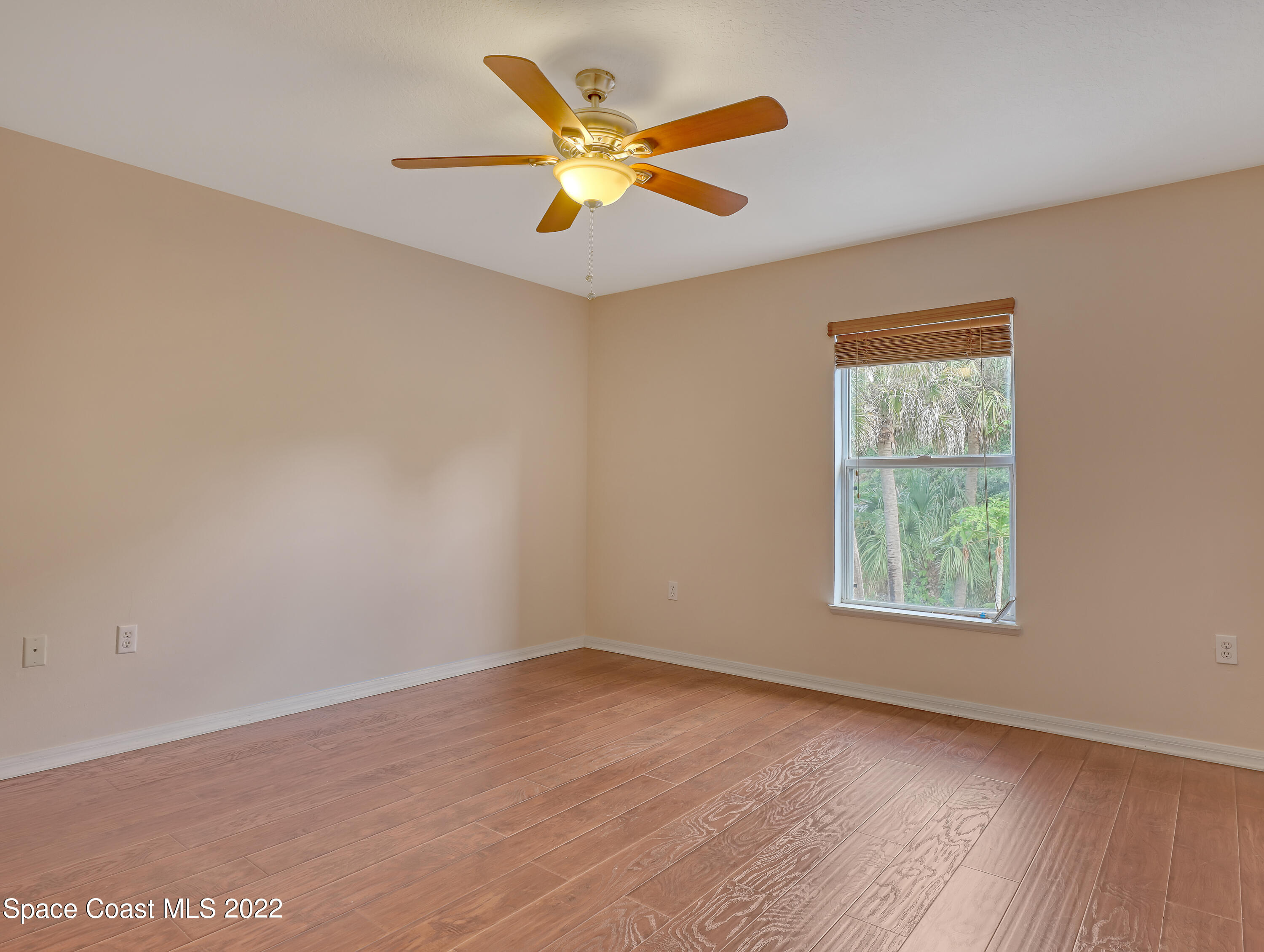 4764 Doreen Road Cocoa, FL 32927 - Photo 30 of 54 an empty room with wooden floor and windows