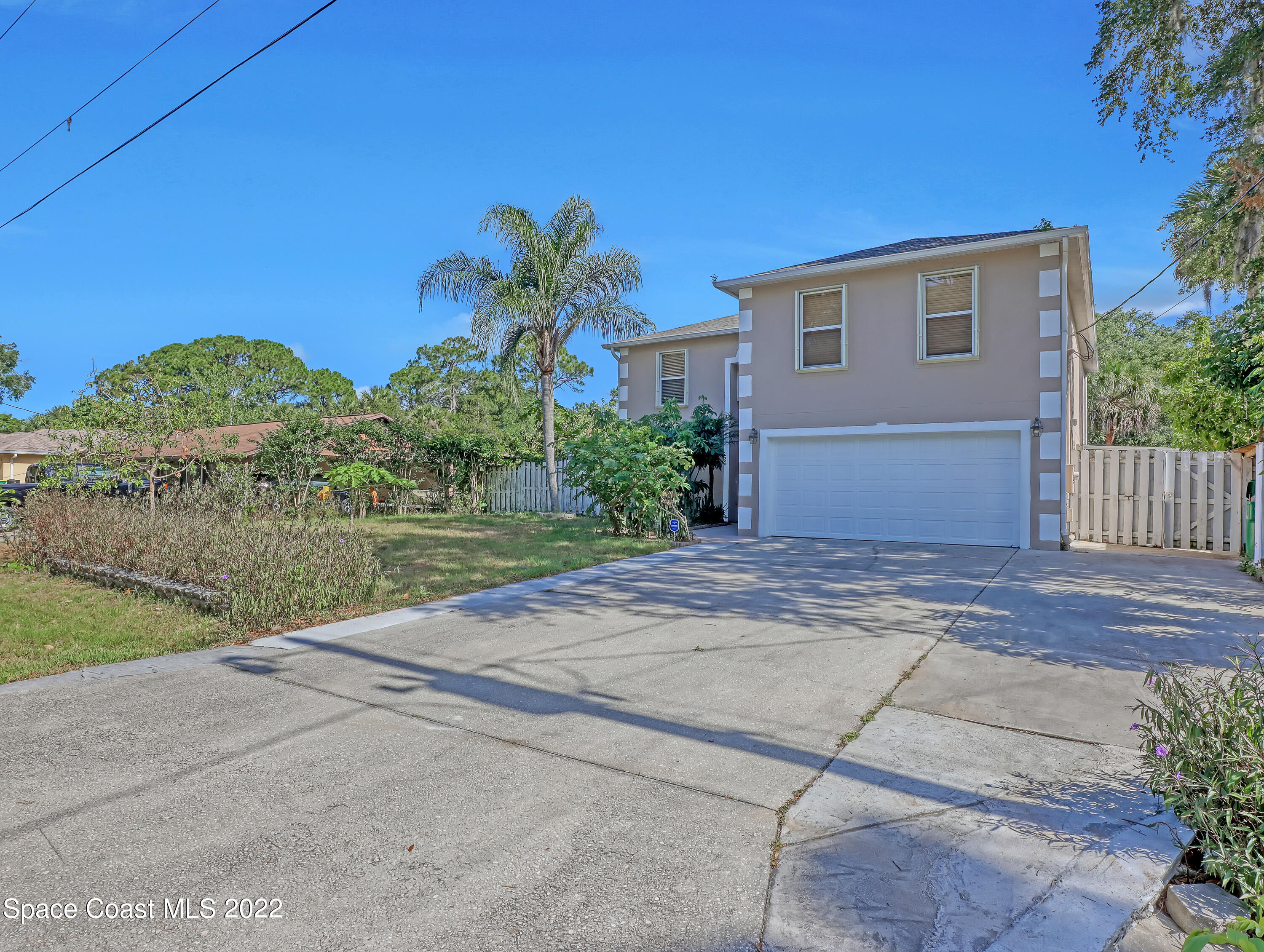 4764 Doreen Road Cocoa, FL 32927 - Photo 3 of 54 a front view of a house with a yard and garage