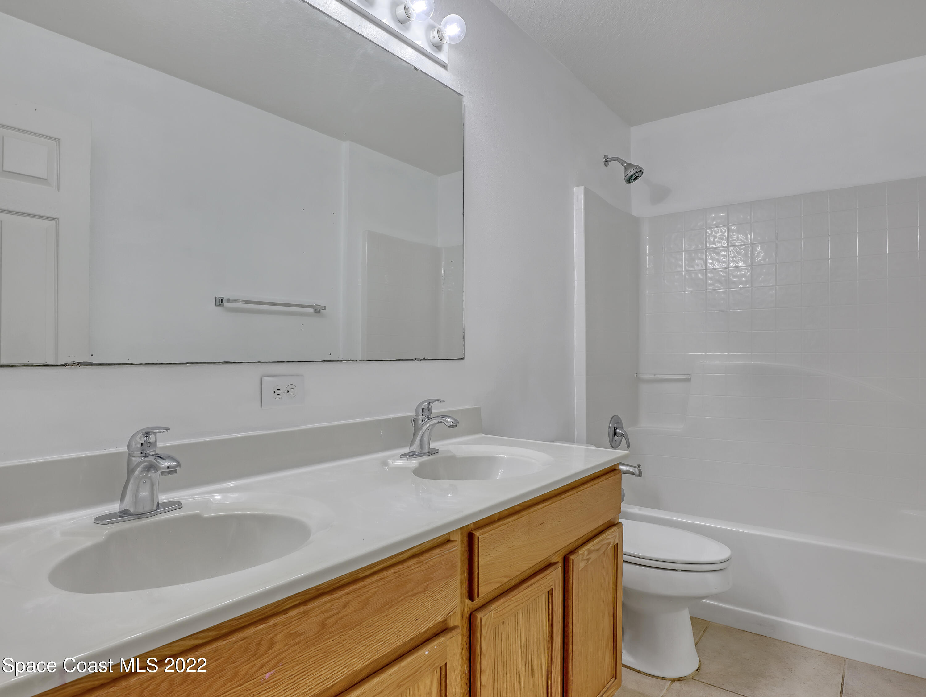 4764 Doreen Road Cocoa, FL 32927 - Photo 32 of 54 a bathroom with a granite countertop sink toilet and shower