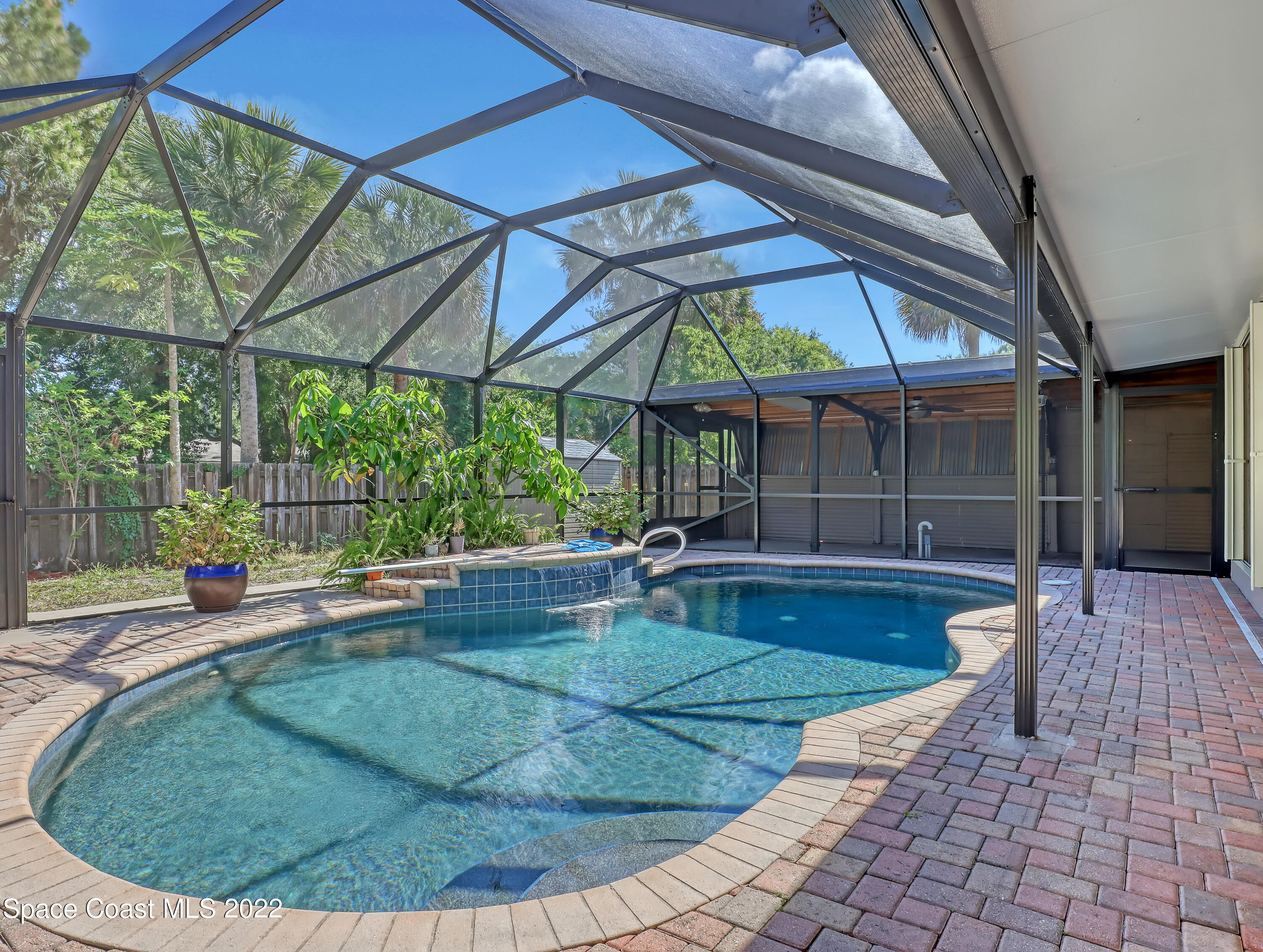 4764 Doreen Road Cocoa, FL 32927 - Photo 39 of 54 a view of a backyard with table and chairs under an umbrella