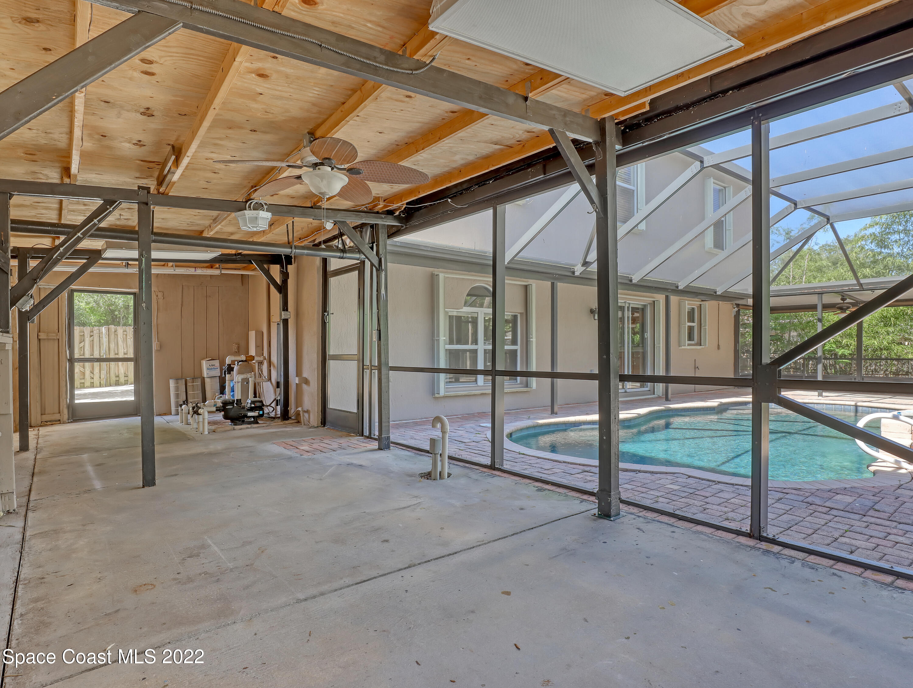 4764 Doreen Road Cocoa, FL 32927 - Photo 46 of 54 a view of an empty room with wooden floor and iron stairs