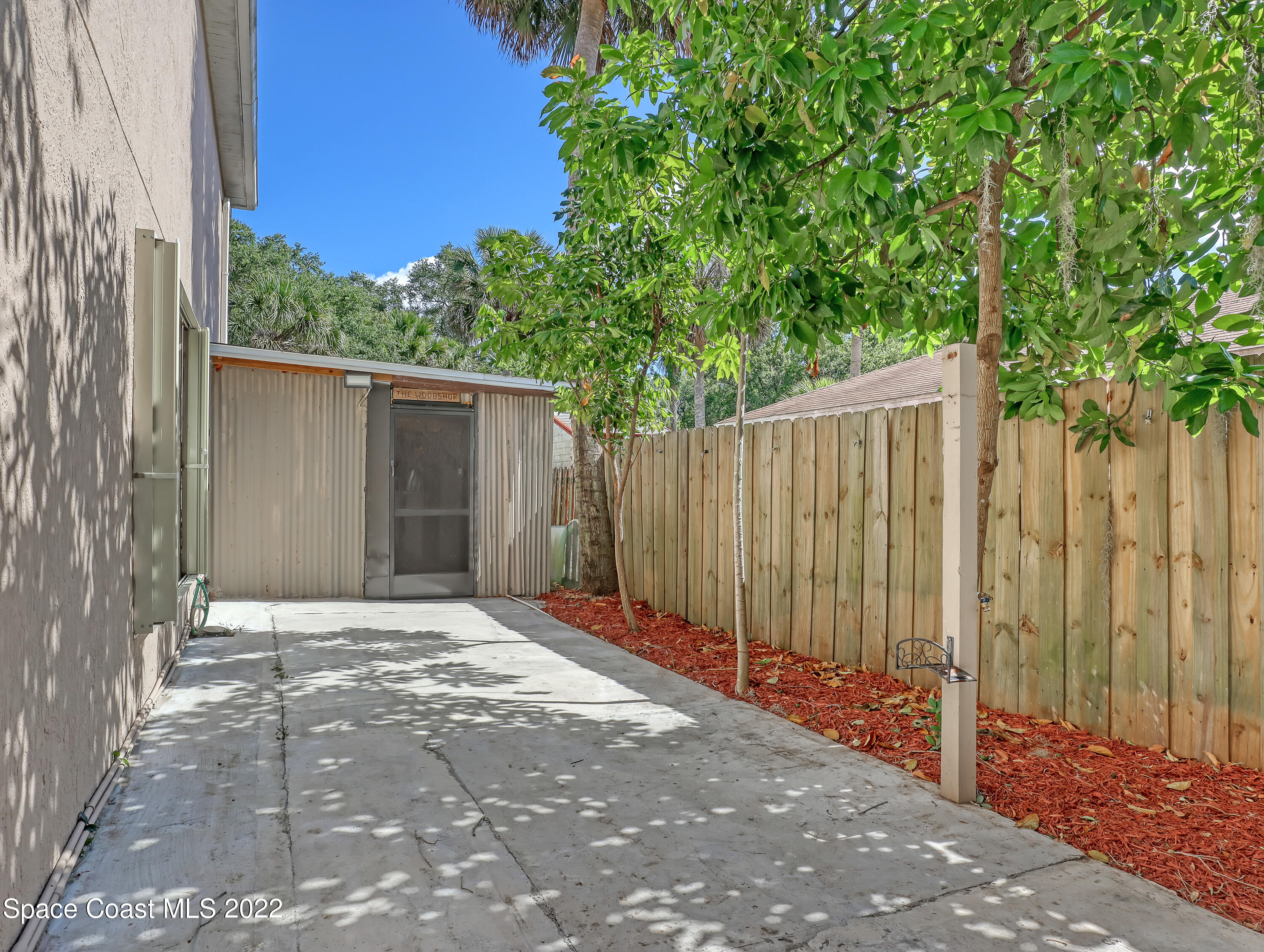 4764 Doreen Road Cocoa, FL 32927 - Photo 48 of 54 a view of backyard with wooden fence and trees