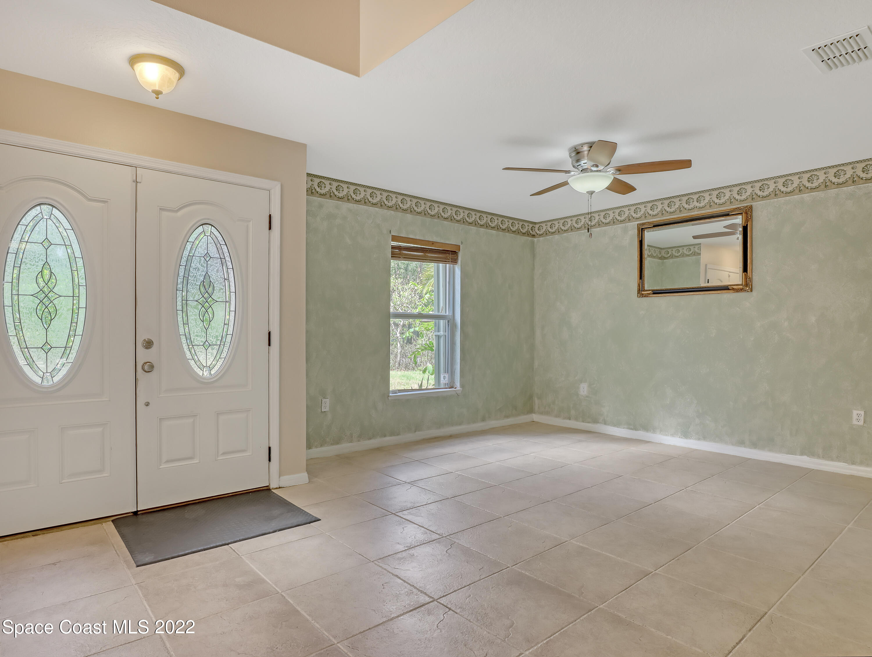 4764 Doreen Road Cocoa, FL 32927 - Photo 7 of 54 a view of an empty room with window cabinet and washer