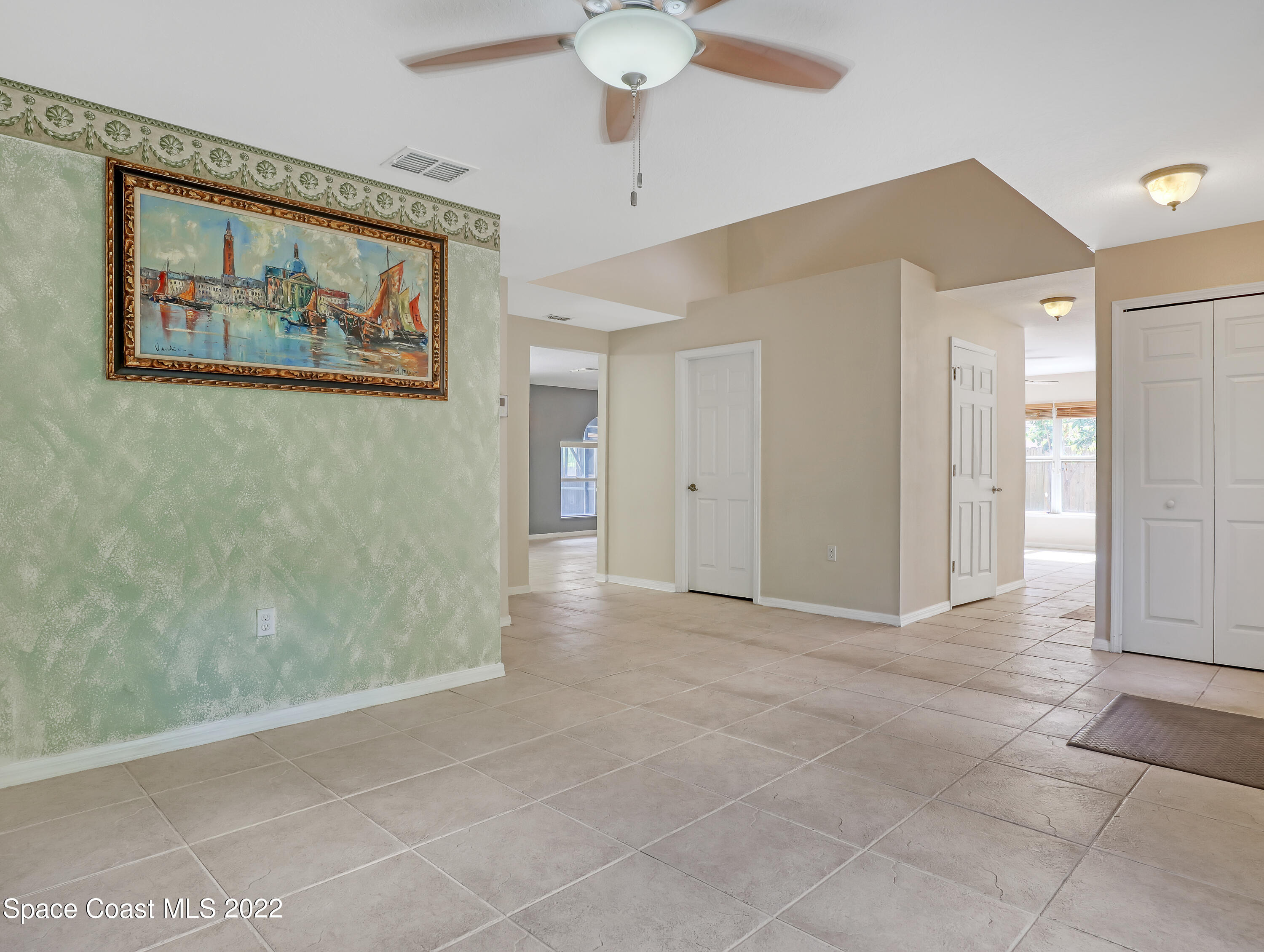 4764 Doreen Road Cocoa, FL 32927 - Photo 8 of 54 a view of a hallway with a chandelier fan