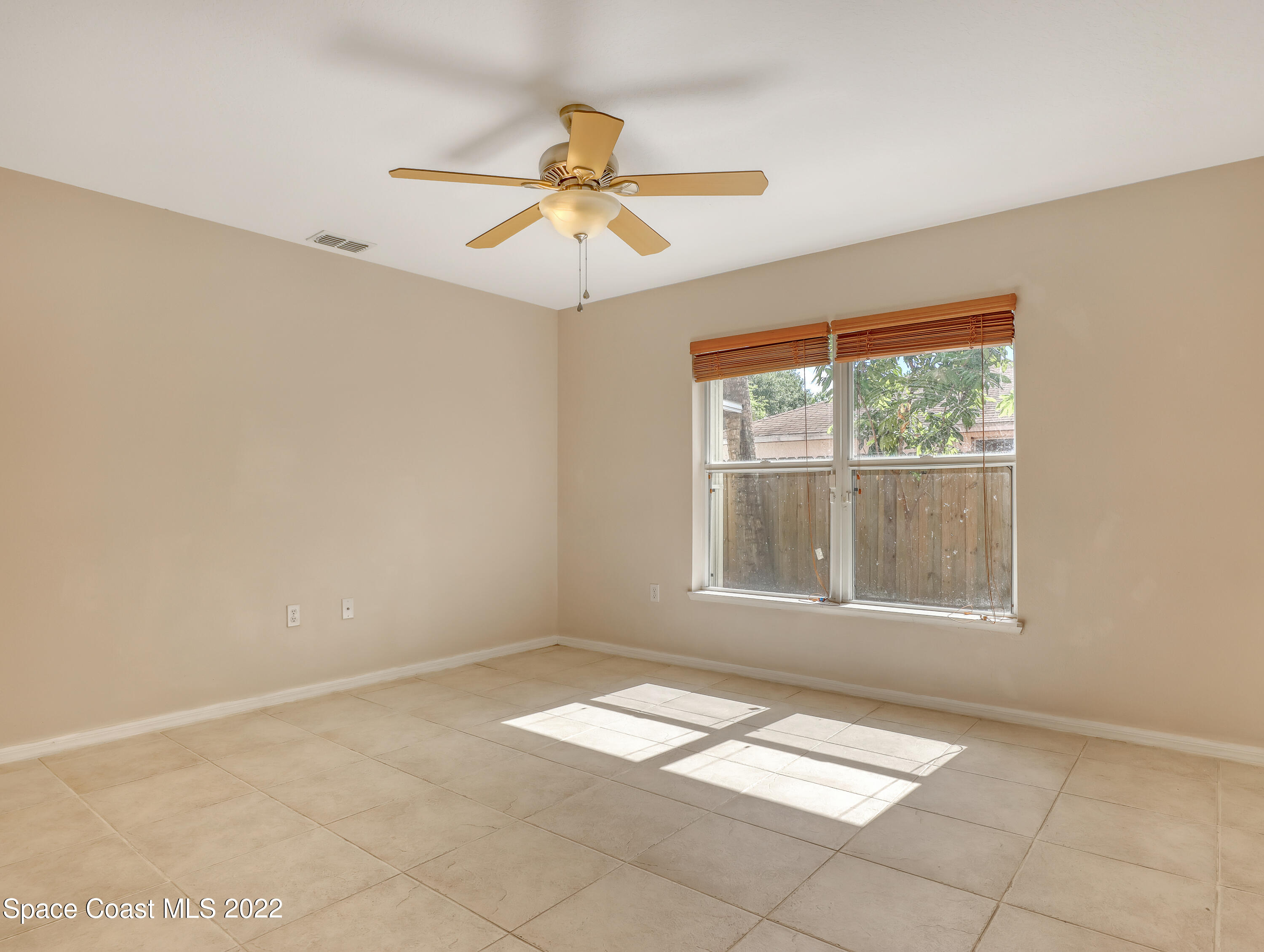 4764 Doreen Road Cocoa, FL 32927 - Photo 10 of 54 an empty room with windows and fan