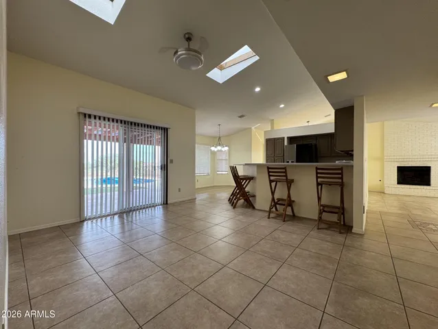 a view of kitchen with stainless steel appliances kitchen island granite countertop a sink and cabinets