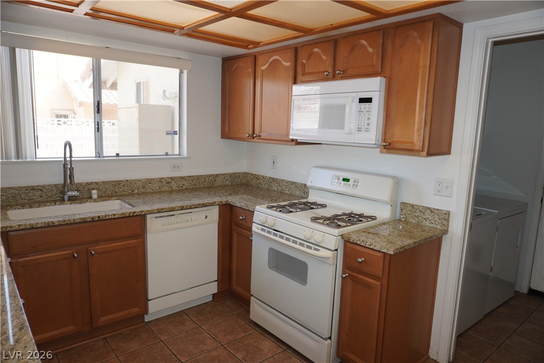 8328 Del Rey Avenue Las Vegas, NV 89117 - Photo 10 of 38 Functional kitchen with ample cabinetry and robust granite counters, ready for culinary endeavors.