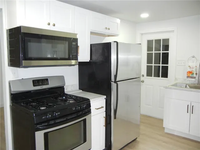 a kitchen with a stove and a microwave