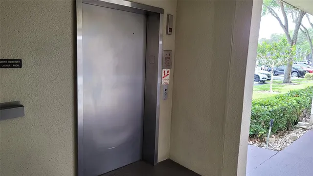 a front view of a house with a garden and a garage