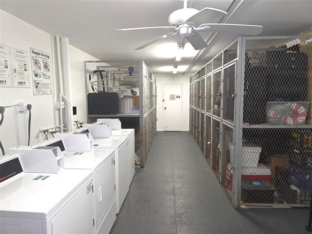 300 Southwest 134th Way, Unit E211 Pembroke Pines, FL 33027 - Photo 14 of 24 a kitchen with kitchen island a sink and a chandelier
