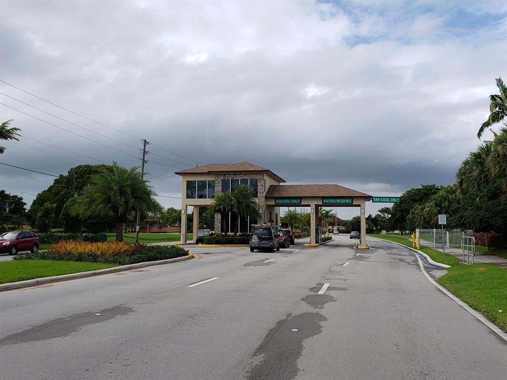 300 Southwest 134th Way, Unit E211 Pembroke Pines, FL 33027 - Photo 16 of 24 a view of a parked cars in front of a house