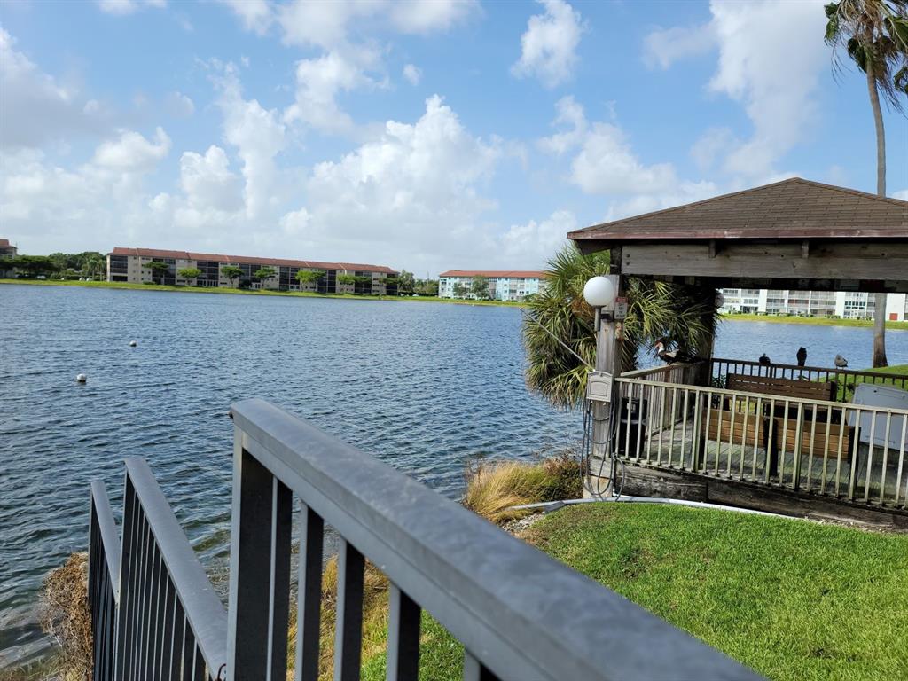 300 Southwest 134th Way, Unit E211 Pembroke Pines, FL 33027 - Photo 24 of 24 a view of a wooden deck with furniture
