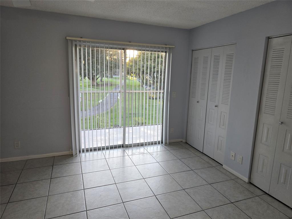 300 Southwest 134th Way, Unit E211 Pembroke Pines, FL 33027 - Photo 8 of 24 a view of empty room with sliding door