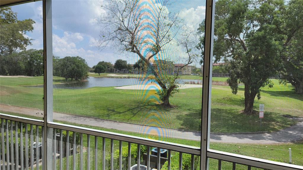300 Southwest 134th Way, Unit E211 Pembroke Pines, FL 33027 - Photo 10 of 24 a view of a porch and a yard