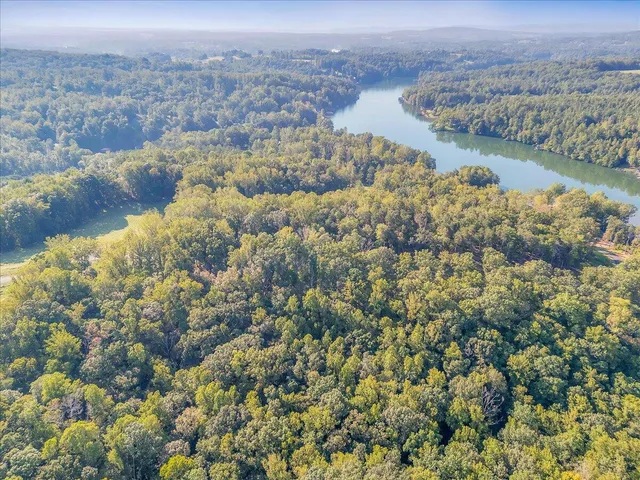 an aerial view of a houses with a lake