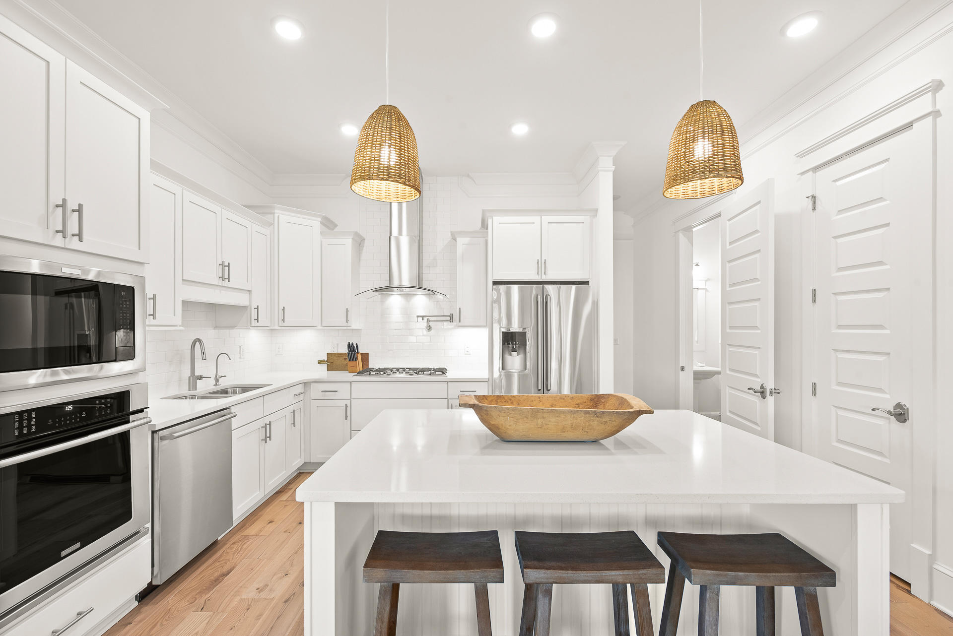 39 Candlehouse Ln Inlet Beach Inlet Beach, FL 32461 - Photo 6 of 26 a kitchen with stainless steel appliances granite countertop a stove a refrigerator a microwave oven with a dining table and chairs