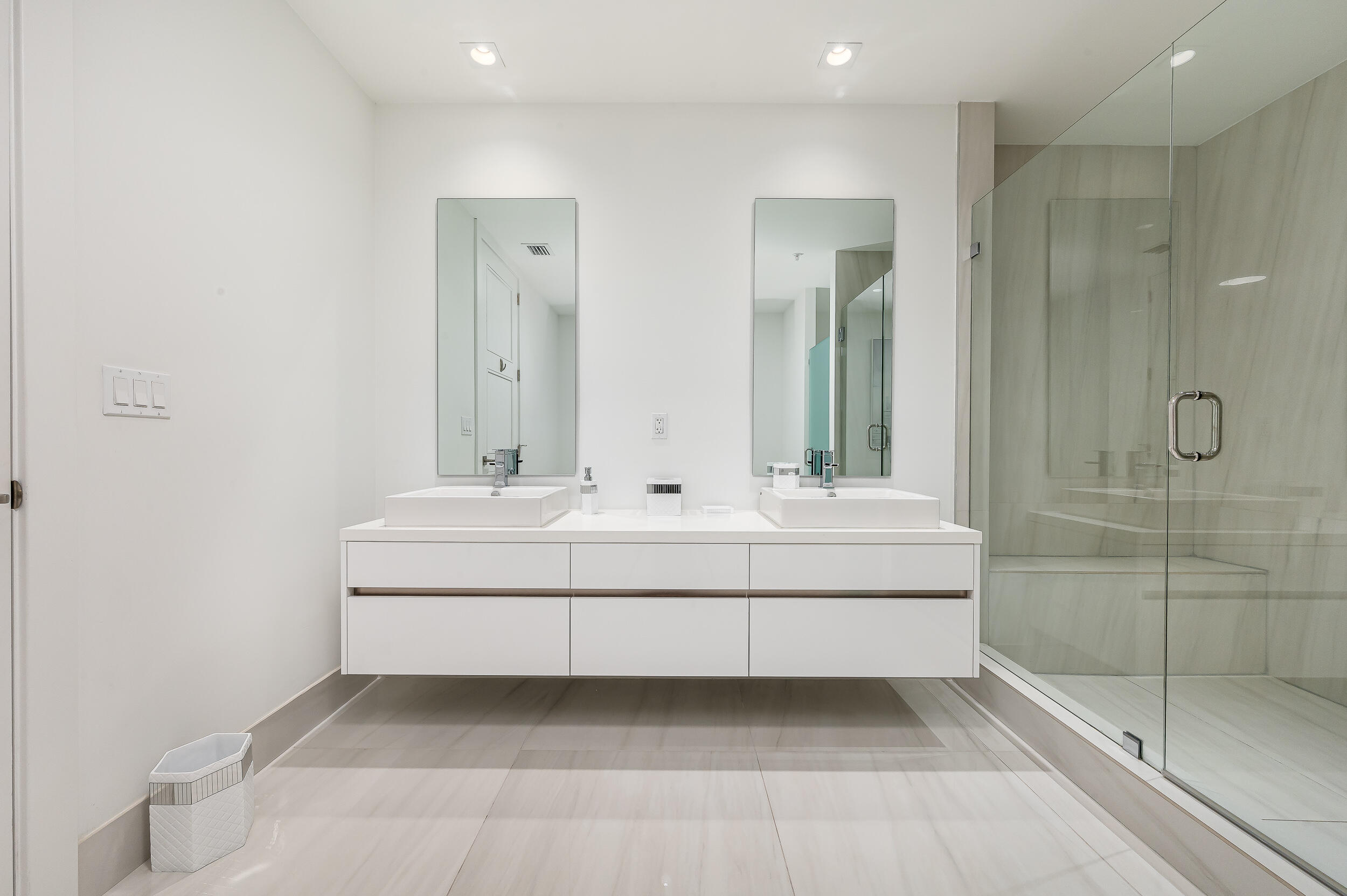 155 East Boca Raton Road, Unit 1103 Boca Raton, FL 33432 - Photo 18 of 57 a bathroom with double vanity sink and mirror