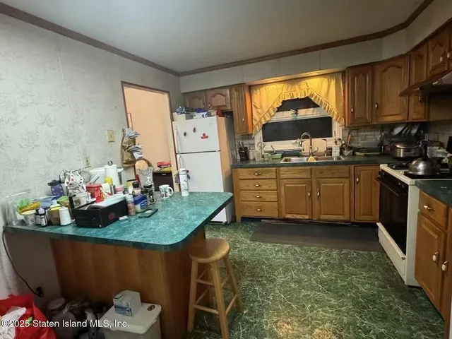 a kitchen with sink cabinets and appliances