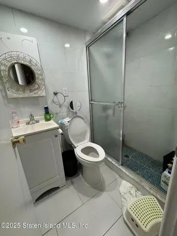 a bathroom with a toilet a sink and shower