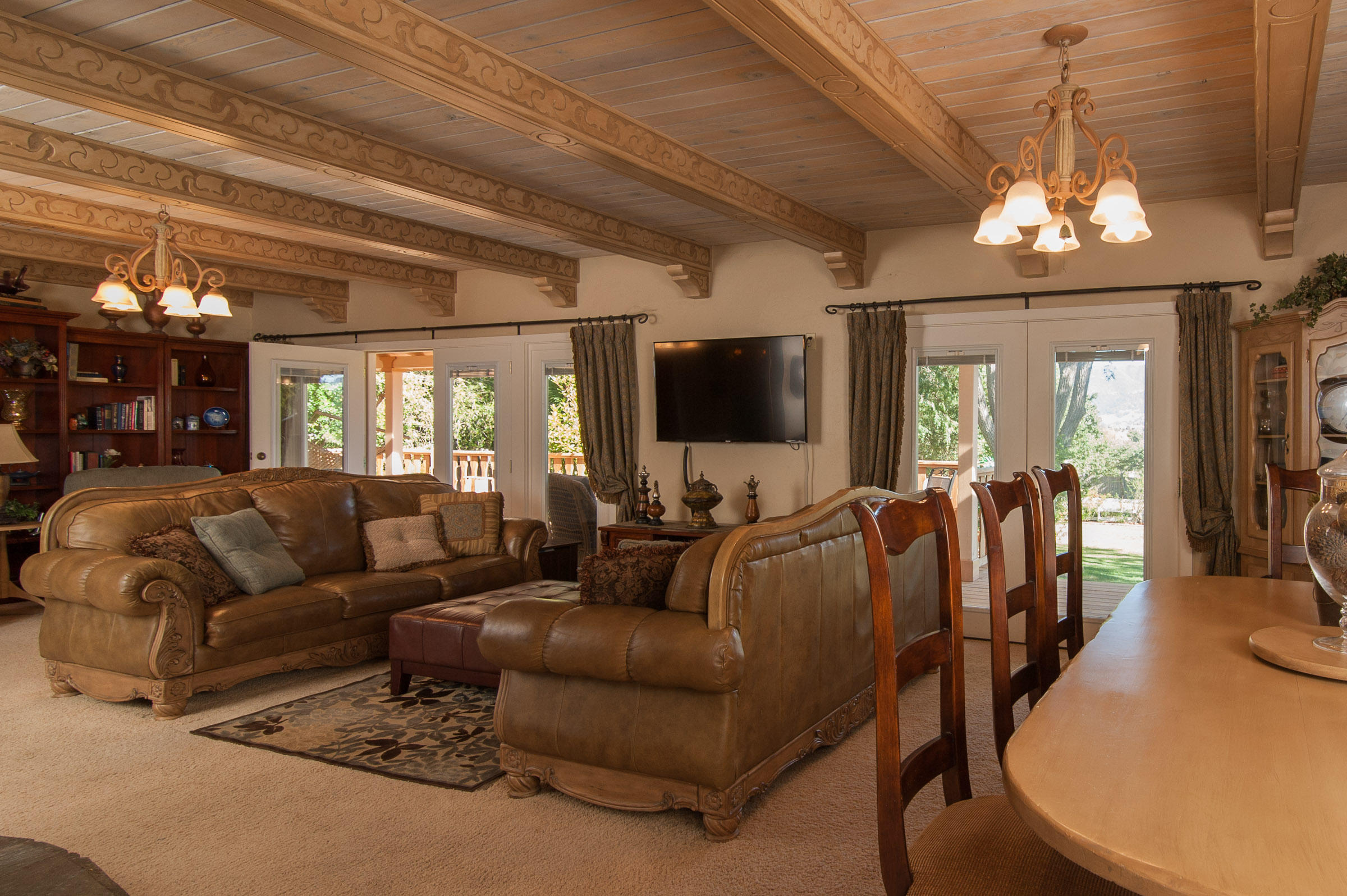 2620 Janin Way Solvang, CA 93463 - Photo 5 of 24 a living room with furniture a chandelier and a flat screen tv