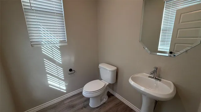 a bathroom with a sink a mirror and a toilet
