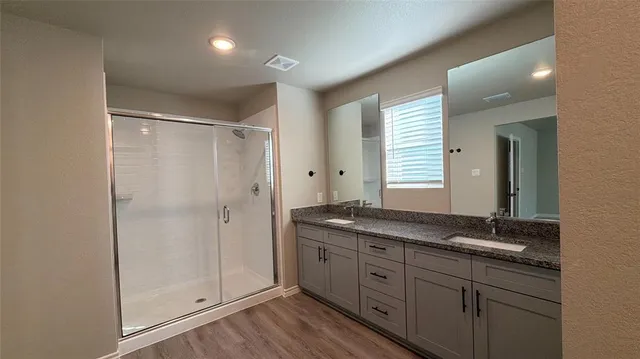 a bathroom with a granite countertop sink a mirror and a