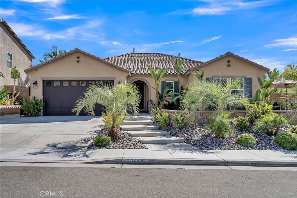 20643 Spring Street Riverside, CA 92507 - Photo 1 of 1 a front view of a house with a yard and garage