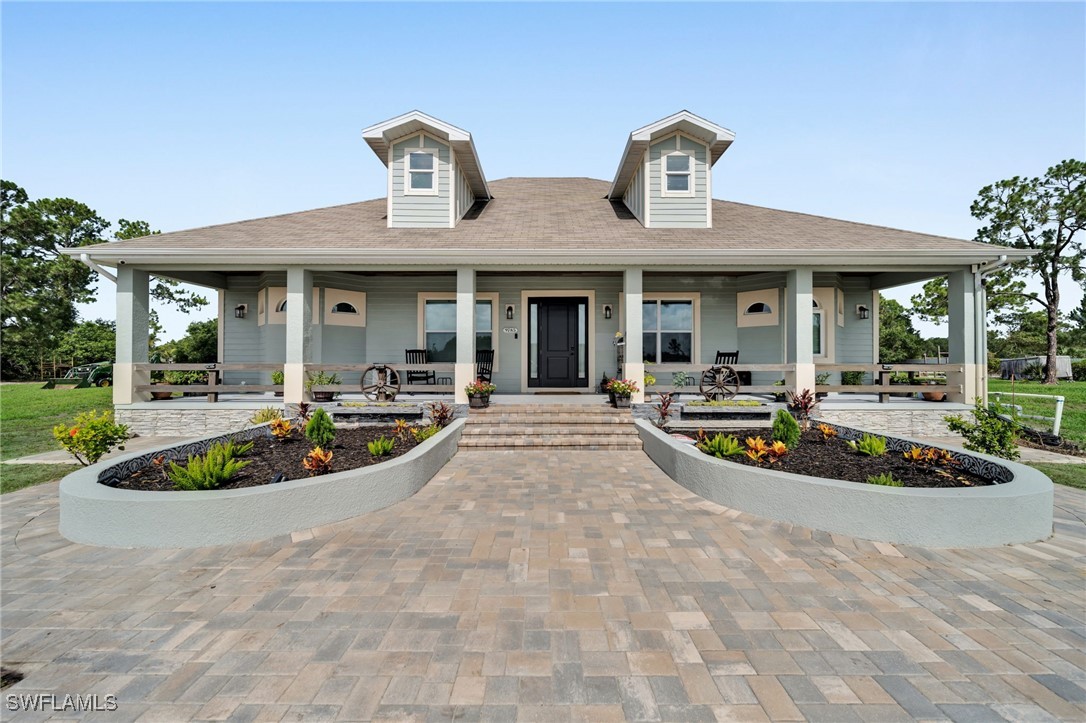 a view of a house with swimming pool and garden
