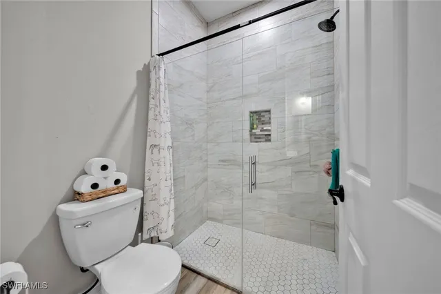 a white toilet sitting next to a bathroom