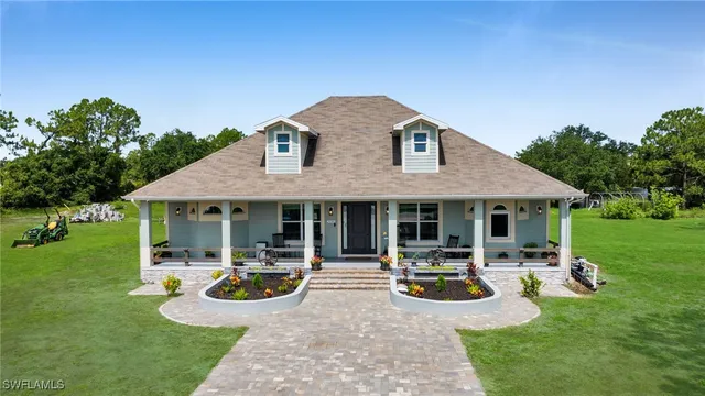 a view of a house with backyard garden and swimming pool