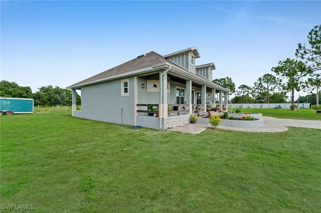 a view of a house with a yard patio and fire pit