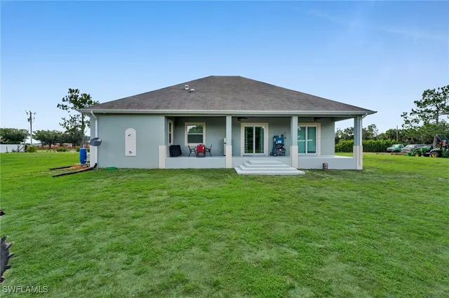 a front view of house with yard and green space