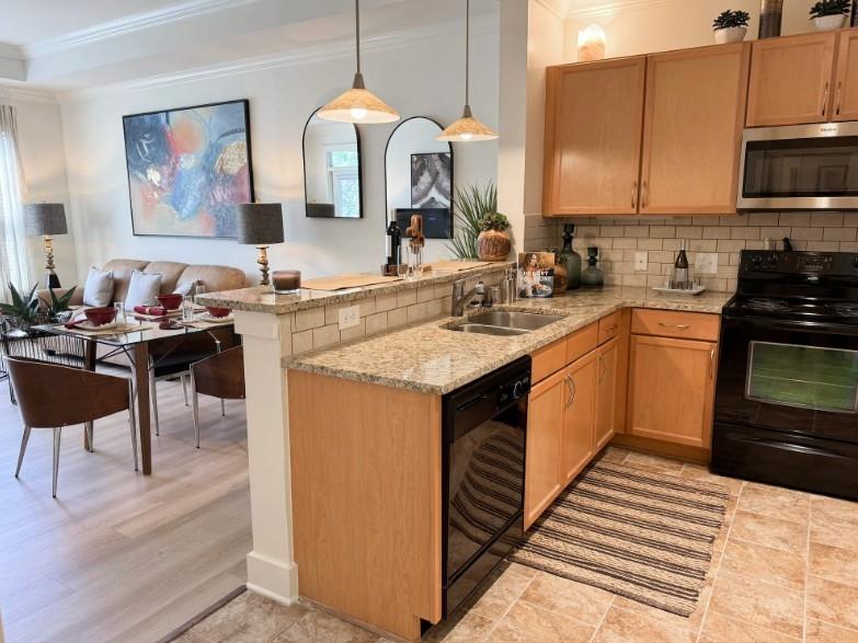 a kitchen with stainless steel appliances granite countertop a sink stove and cabinets